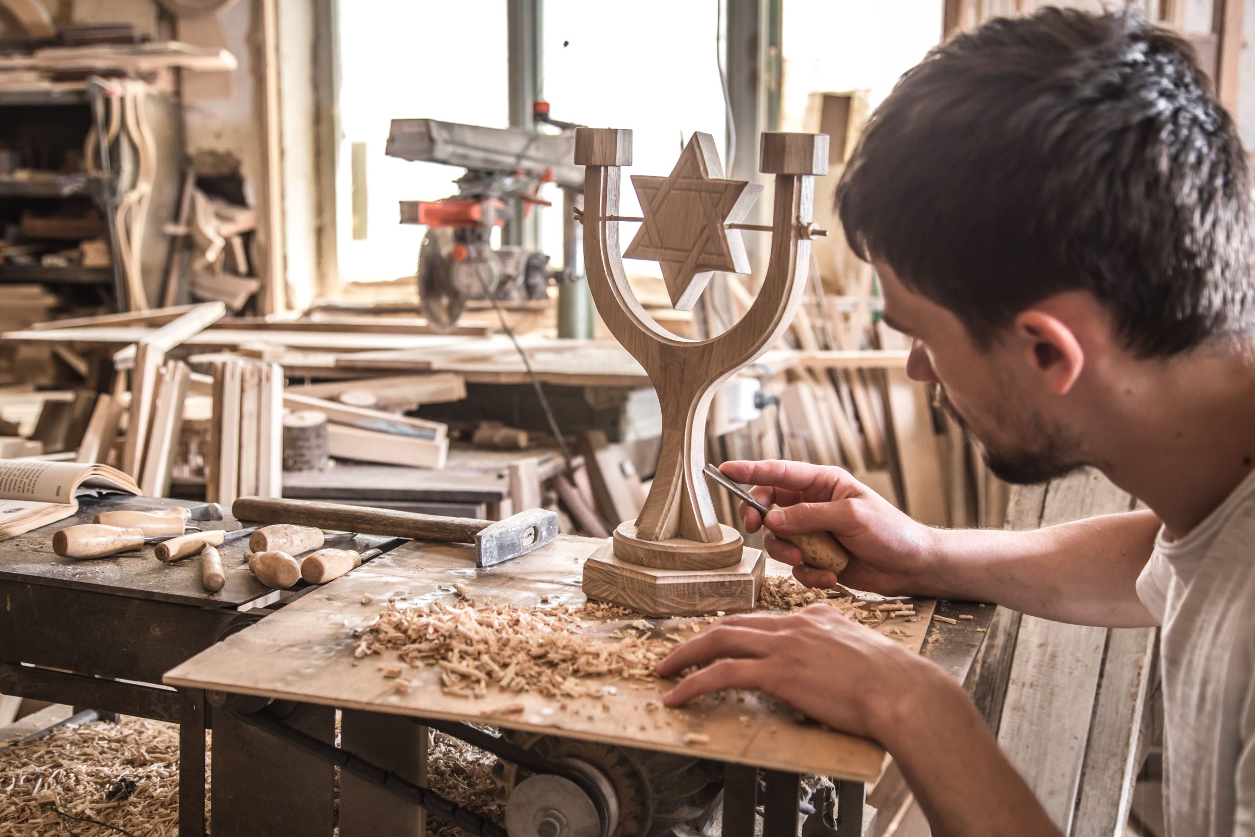 male-carpenter-working-with-wood-product-hand-tools-1-scaled